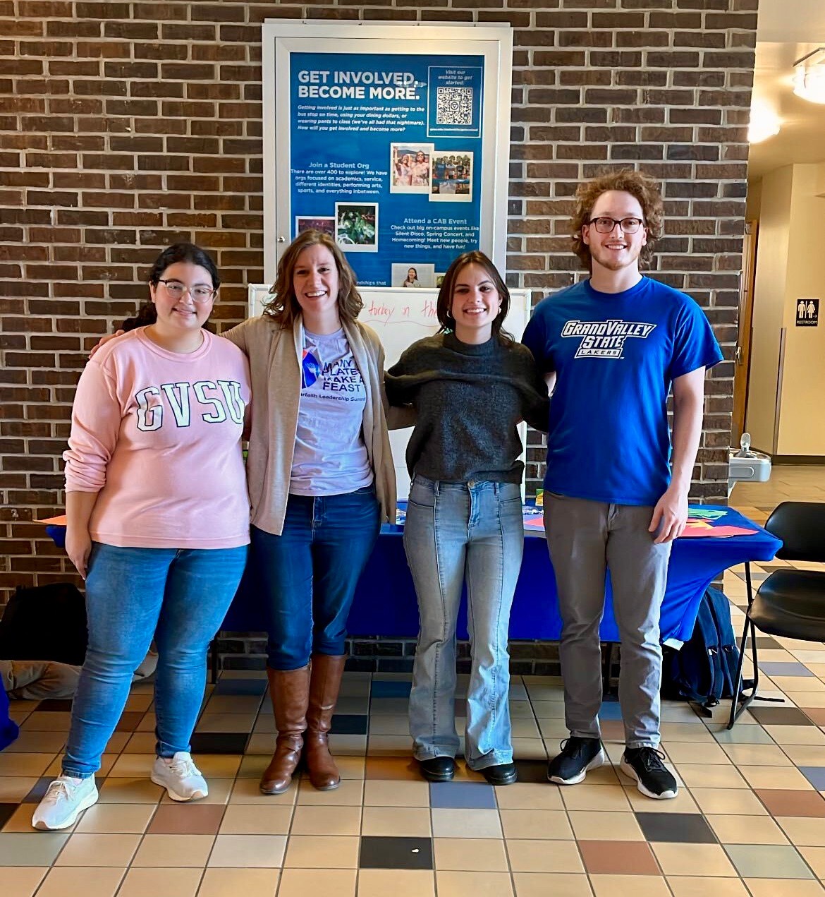 Four people standing together